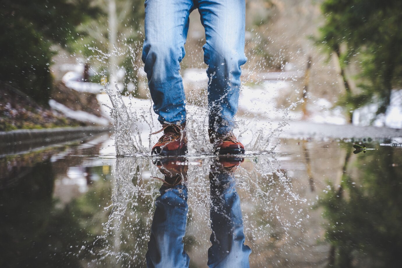 Man standing in a puddle - Landscape of Guildford - Water Damage Insurance Claims in Guildford